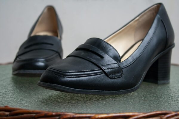 Close-up of stylish black leather women's loafers, perfect for fashion-forward styling.