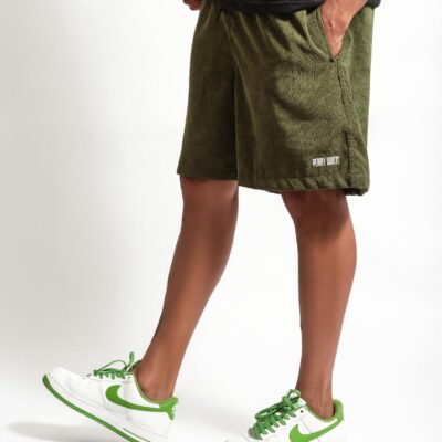 Stylish casual wear featuring green sneakers and shorts for a fashionable look.